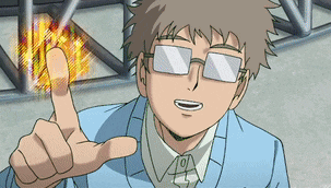 a man wearing glasses and a blue jacket giving a thumbs up