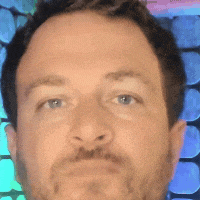 a close up of a man 's face with blue eyes