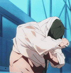 a man with a white shirt and green hair is kneeling down