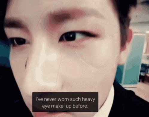 a close up of a man 's face with the words i 've never worn such heavy eye make-up before ..