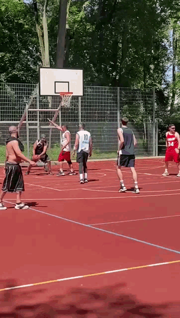 a group of men are playing basketball on a court and one of the players has the number 34 on his shorts
