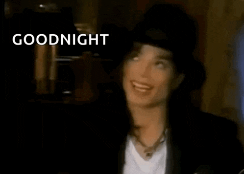 a close up of a man in a hat giving a thumbs up and saying goodnight .