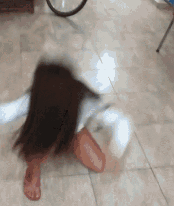 a blurry picture of a woman laying on the floor .