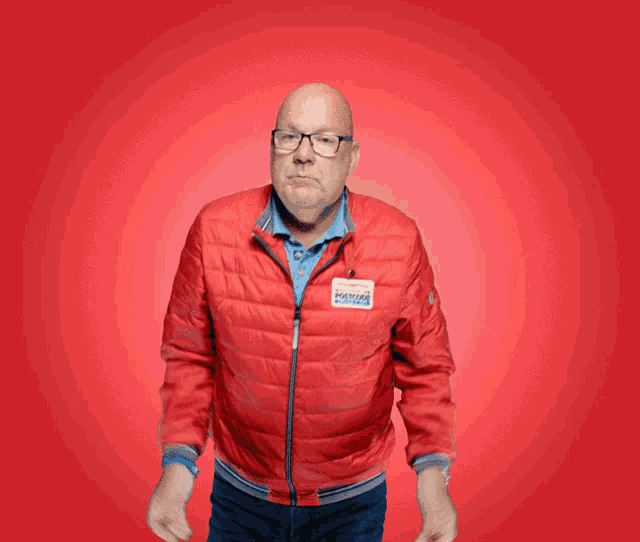 a man wearing a red jacket with a patch that says boston patriots