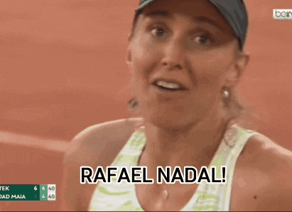 a woman says rafael nadal in front of a score board