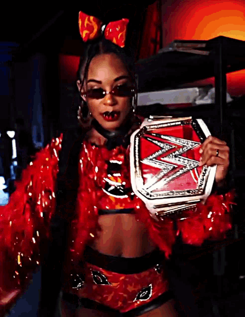 a woman in a red outfit is holding a trophy