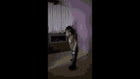 a person is standing on their knees in a dark room .