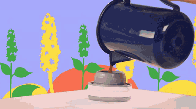 a person pouring a blue cup of liquid into a cup