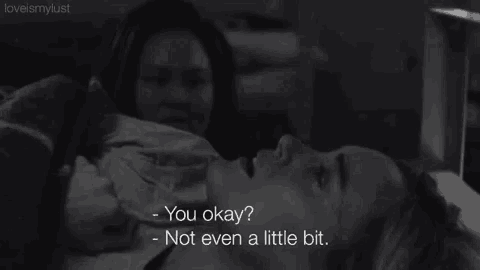 a black and white photo of a woman laying on a bed with the caption " you okay "