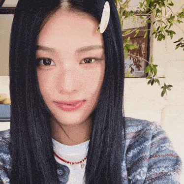 a woman with black hair has a hair clip in her hair