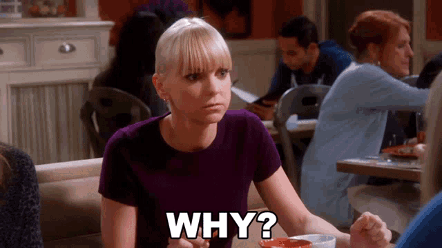 a woman sitting at a table with the words " why " written on it