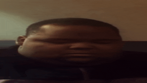 a close up of a man 's face with a serious look on his face