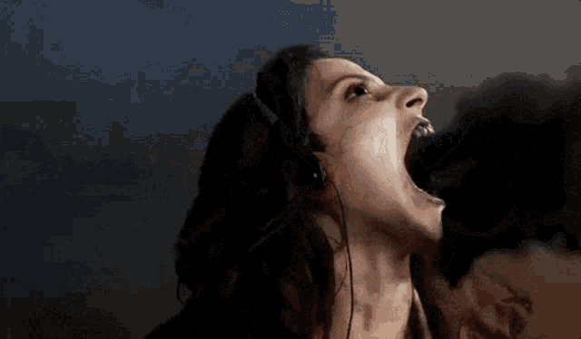 a woman wearing headphones with her mouth wide open