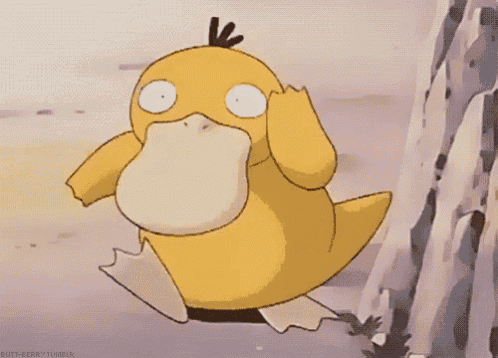 a yellow duck with a black feather on its head is standing next to a rock .
