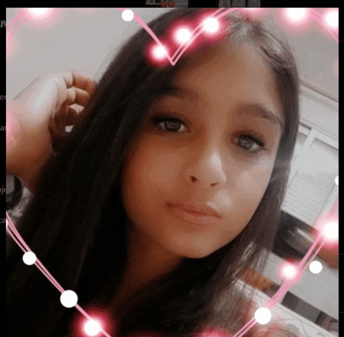 a girl 's face is surrounded by pink hearts and lights