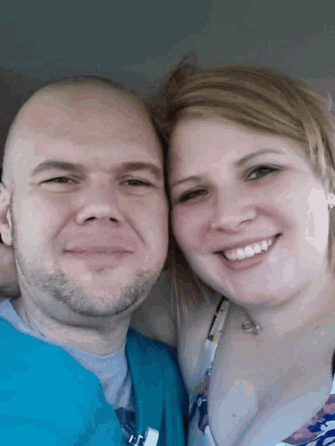 a man and a woman are posing for a picture