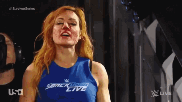 a woman wearing a blue shirt that says smackdown live on it