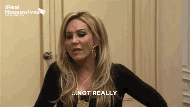 a woman says " not really " in front of a real housewives ad