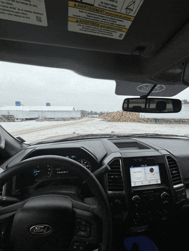 the inside of a ford truck with a sticker on the windshield that says avertissement
