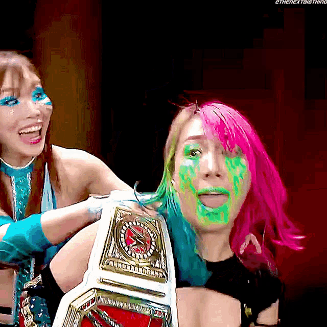 a woman with green paint on her face is holding a wrestling championship belt