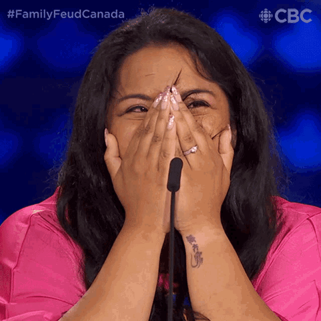 a woman covering her face with her hands and a cbc logo