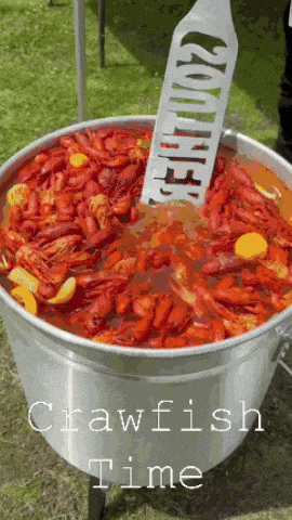 a large pot of crawfish with a spatula that says crawfish