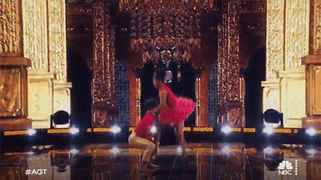 a couple of dancers on a stage with #agt on the bottom