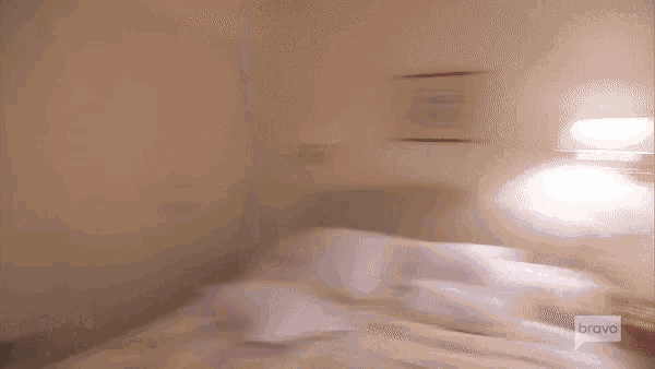a blurry picture of a bed with bravo on the bottom right