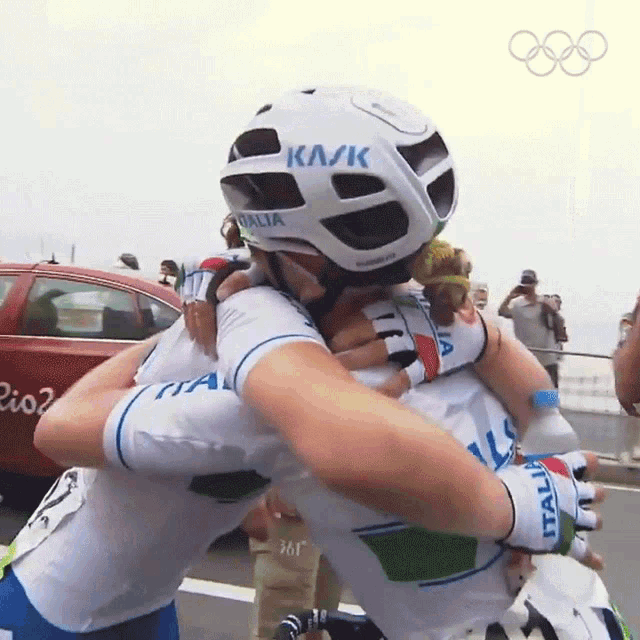 a person wearing a helmet that says ka/k on it hugging another person