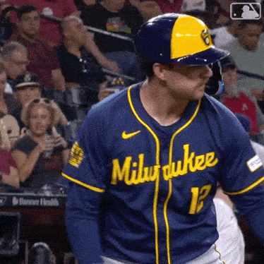 a baseball player wearing a milwaukee jersey