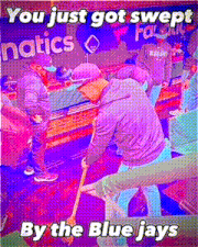 a man is sweeping the floor with a sign that says ' you just got swept by the blue jays ' in the background