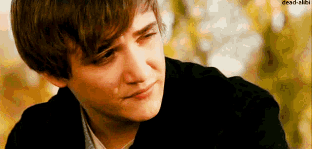 a young man with a tear running down his cheek