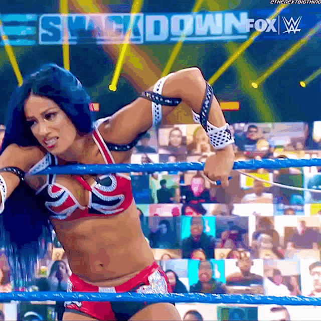 a woman in a bikini is in a wrestling ring with the words smackdown fox on the bottom