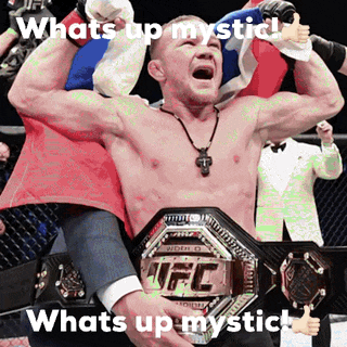 a man is holding a ufc championship belt in his hands