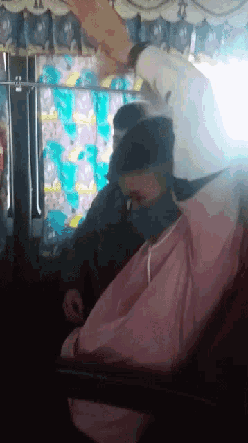 a man wearing a mask is getting his hair cut