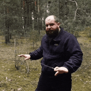 a man with a beard wearing a black jacket that says columbia on it