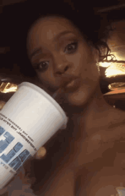 a woman is drinking from a cup that says ' ice ' on it