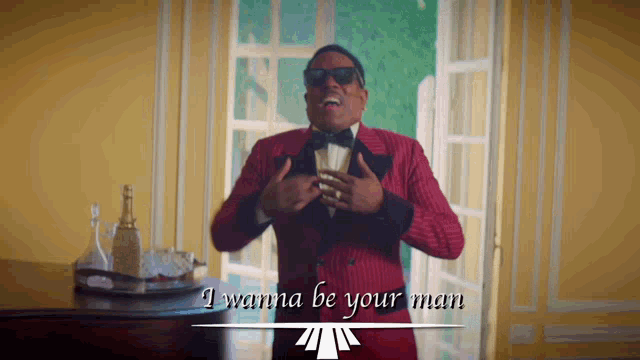 a man in a red tuxedo and bow tie singing i wanna be your man