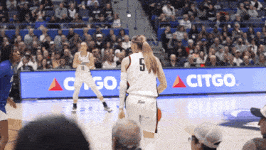 a female basketball player wearing a number 5 jersey