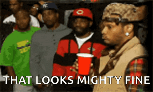 a group of men are standing in a line with the words that looks mighty fine above them