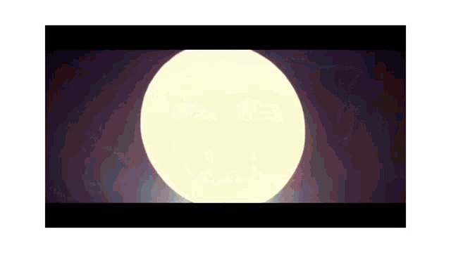 a man in a batman costume stands in front of a full moon