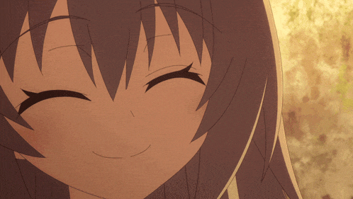 a close up of a girl 's face smiling with her eyes closed