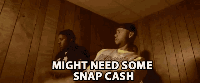 a man sitting in front of a wooden wall with the words " might need some snap cash " above him
