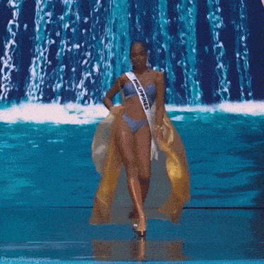 a woman in a bikini is wearing a sash that says philippines on it