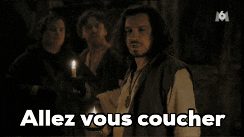 a man stands in front of a sign that says allez vous couche