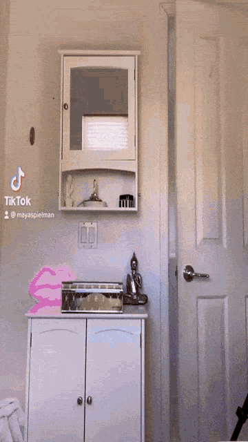 a woman is standing in front of a mirror in a bathroom with tiktok written on the bottom