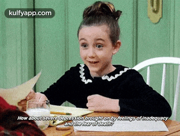 a little girl is sitting at a table with a glass of milk and a piece of paper ..