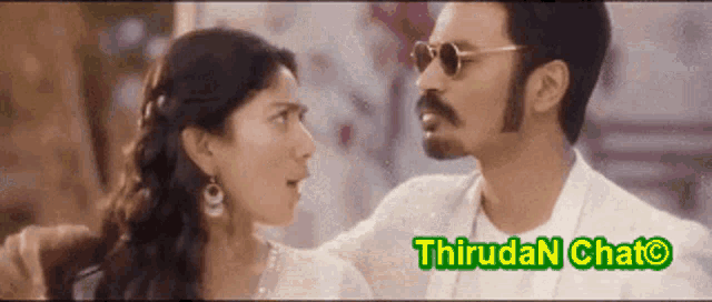 a man and a woman are looking at each other with the words thirudan chato written below them