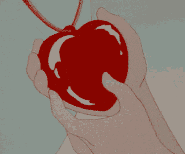 a person holding a pair of red sunglasses in their hand