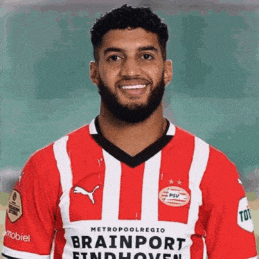 a man with a beard wears a red and white striped shirt that says brainport findhoven
